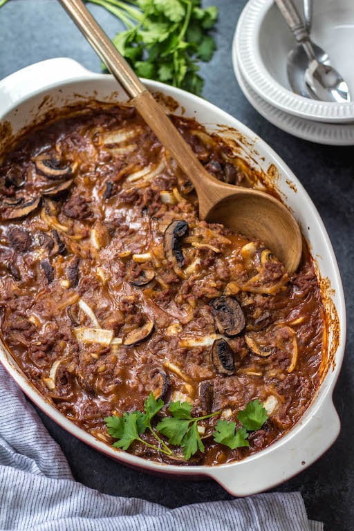 This Whole30 casserole is everything you love about classic salisbury steak, but it's made with only the good stuff! Healthy, hearty and cozy, this salisbury steak casserole is loaded with vegetables, a thick gravy, and baked all in one dish. It's a perfect Paleo and gluten-free family friendly weeknight dinner, or a great meal prep recipe for leftovers that reheat wonderfully! #whole30casserole #whole30beefrecipes #whole30beefcasserole #paleocasserole #paleobeefrecipes #salisburysteak