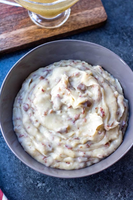 Whole30 creamy mashed potatoes in the slow cooker are a staple for a weeknight side dish, a meal prep recipe, or a holiday gathering. A perfect Paleo, dairy-free, and gluten-free side dish that’s full of comfort and incredibly easy. This family friendly favorite can be paired with just about anything and meal preps amazingly. #whole30sidedish #whole30mashedpotatoes #whole30slowcooker #paleoslowcooker #paleosidedish