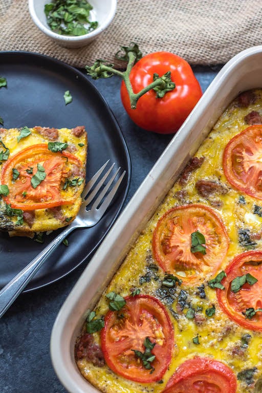 This Whole30 breakfast casserole is filled with sausage, tomato, basil and potatoes, and couldn't be easier to whip up for a Whole30 or Paleo breakfast meal prep recipe. With only a few simple ingredients and a bit of oven baking magic, you'll have a family friendly, gluten-free, and Whole30 egg bake, or be set for the week ahead! #whole30eggbake #whole30breakfastrecipes #whole30breakfastcasserole #paleobreakfast #glutenfreebreakfast #whole30sausagerecipes