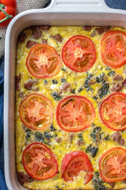 This Whole30 breakfast casserole is filled with sausage, tomato, basil and potatoes, and couldn't be easier to whip up for a Whole30 or Paleo breakfast meal prep recipe. With only a few simple ingredients and a bit of oven baking magic, you'll have a family friendly, gluten-free, and Whole30 egg bake, or be set for the week ahead! #whole30eggbake #whole30breakfastrecipes #whole30breakfastcasserole #paleobreakfast #glutenfreebreakfast #whole30sausagerecipes
