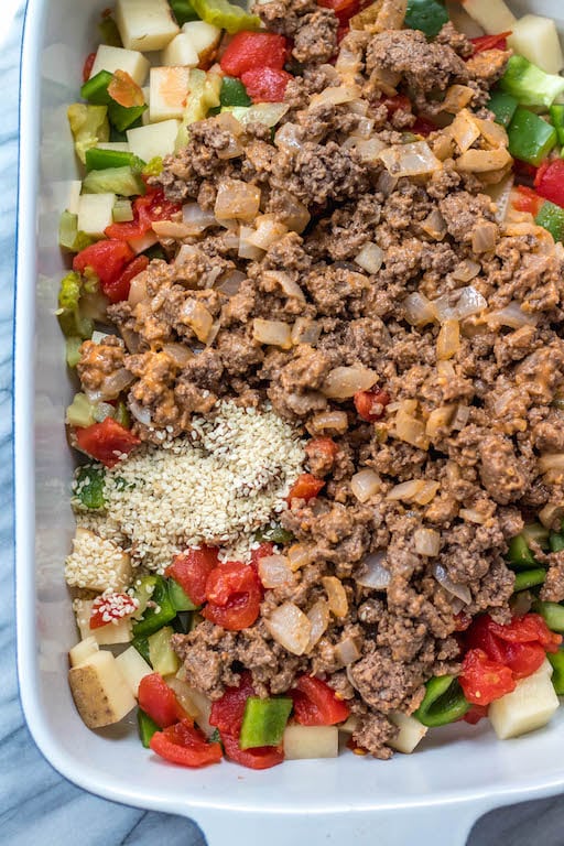 This is a delicious and easy Whole30 ground beef casserole recipe that is a healthy take on a big mac! The classic flavors you know and love, all baked together in a paleo, gluten free Big Mac casserole that's loaded with veggies. It's great for a family friendly weeknight meal, or for meal prep lunches for the week. #whole30casserole #whole30groundbeef #whole30dinnerrecipes #paleogroundbeef #glutenfree
