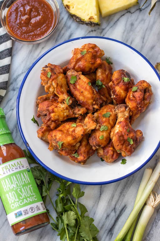 These slow cooker BBQ chicken wings are perfect for meal prep, or for a healthy appetizer or snack. They've got a Hawaiian spin to add some exciting flavor to the BBQ, only a few simple ingredients in a crockpot, and are Whole30, paleo and gluten-free. This is a great hands-off method to cook an easy chicken recipe everyone will love. #whole30slowcooker #whole30chickenwings #crockpotchicken #healthychickenwings #paleochickenrecipes