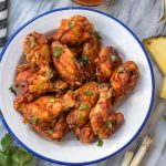 These slow cooker BBQ chicken wings are perfect for meal prep, or for a healthy appetizer or snack. They've got a Hawaiian spin to add some exciting flavor to the BBQ, only a few simple ingredients in a crockpot, and are Whole30, paleo and gluten-free. This is a great hands-off method to cook an easy chicken recipe everyone will love. #whole30slowcooker #whole30chickenwings #crockpotchicken #healthychickenwings #paleochickenrecipes