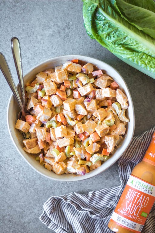 This healthy and easy buffalo chicken salad only takes a few simple ingredients, and is Whole30, paleo, low carb and gluten-free. It's got the perfect buffalo tang, while still being creamy and delicious! This recipe makes the perfect meal prep recipe, done in under 30 minutes, and that can be turned into many meals and enjoyed over greens, in wraps or straight out of the bowl. #whole30recipes #whole30chickenrecipes #ketochickenrecipes #chickensalad #buffalochicken #paleochickenrecipes #whole30mealprep