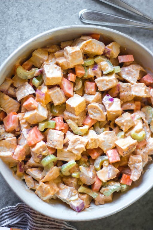 This healthy and easy buffalo chicken salad only takes a few simple ingredients, and is Whole30, paleo, low carb and gluten-free. It's got the perfect buffalo tang, while still being creamy and delicious! This recipe makes the perfect meal prep recipe, done in under 30 minutes, and that can be turned into many meals and enjoyed over greens, in wraps or straight out of the bowl. #whole30recipes #whole30chickenrecipes #ketochickenrecipes #chickensalad #buffalochicken #paleochickenrecipes #whole30mealprep