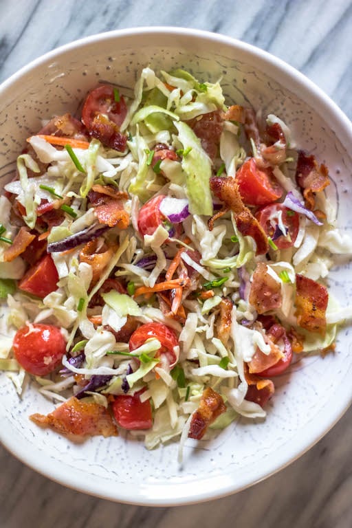 This easy BLT coleslaw is a light and flavorful side dish. It's Whole30, paleo, keto and gluten-free, all while not skimping on flavor. Creamy and healthy, the bacon and extra veggies added into this family favorite recipe are sure to be a hit! #whole30recipes #whole30sidedish #ketorecipes #lowcarb #coleslaw #ketobaconrecipes #paleorecipes