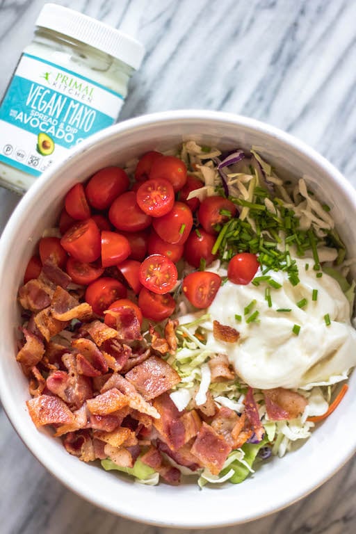 This easy BLT coleslaw is a light and flavorful side dish. It's Whole30, paleo, keto and gluten-free, all while not skimping on flavor. Creamy and healthy, the bacon and extra veggies added into this family favorite recipe are sure to be a hit! #whole30recipes #whole30sidedish #ketorecipes #lowcarb #coleslaw #ketobaconrecipes #paleorecipes
