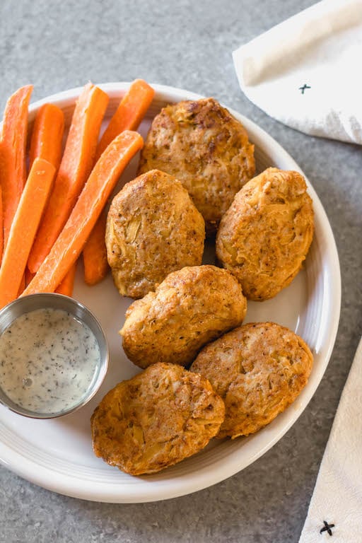 These easy butternut squash chicken nuggets are a healthy, Whole30 and gluten-free alternative to traditional nuggets. This recipe is a great way to sneak vegetables in, and are totally kid and family friendly, and paleo and low carb, too. With only a few ingredients, they're also quick to make for a weeknight meal or meal prep! #whole30recipes #whole30chicken #paleorecipes #paleochickenrecipes #lowcarb #keto #chickennuggets #glutenfreechicken #dinnerrecipes