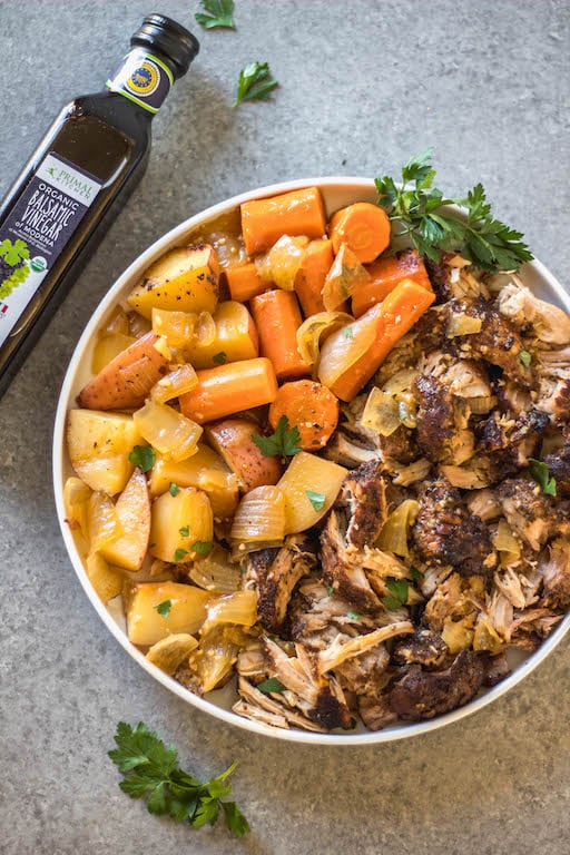 This easy and tender pork roast only takes a few ingredients and lets the slow cooker do the work for you! It's a healthy family friendly recipe for dinner or meal prep, and is Whole30, paleo and gluten-free. The delicious vegetables, plus the gravy, are all made in right in the crock pot with the pork shoulder, so this hearty and comforting dinner is completely ready when you are! #whole30recipes #whole30slowcooker #whole30pork #paleo #slowcookerpork #glutenfree #winterrecipes #porkrecipes