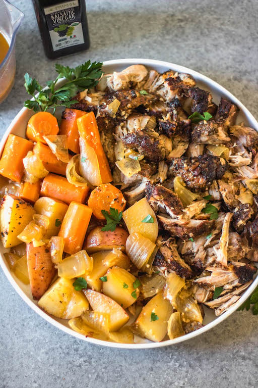 This easy and tender pork roast only takes a few ingredients and lets the slow cooker do the work for you! It's a healthy family friendly recipe for dinner or meal prep, and is Whole30, paleo and gluten-free. The delicious vegetables, plus the gravy, are all made in right in the crock pot with the pork shoulder, so this hearty and comforting dinner is completely ready when you are! #whole30recipes #whole30slowcooker #whole30pork #paleo #slowcookerpork #glutenfree #winterrecipes #porkrecipes