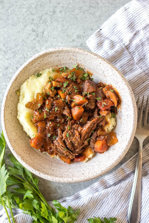 This slow cooker beef ragu is the perfect cozy and hearty weeknight meal or meal prep recipe that's not only Whole30, paleo, and gluten-free, but it is incredibly delicious. It's loaded with vegetables, easy to prepare and takes almost no hands-on cooking time thanks to the crock pot. It also freezes really well! This is sure to be a family favorite, and a go-to recipe when you need a quick meal to be ready for dinner. #whole30slowcooker #whole30recipes #paleoslowcooker #slowcookerbeefragu #whole30beef #bestwhole30recipes #whole30weeknight