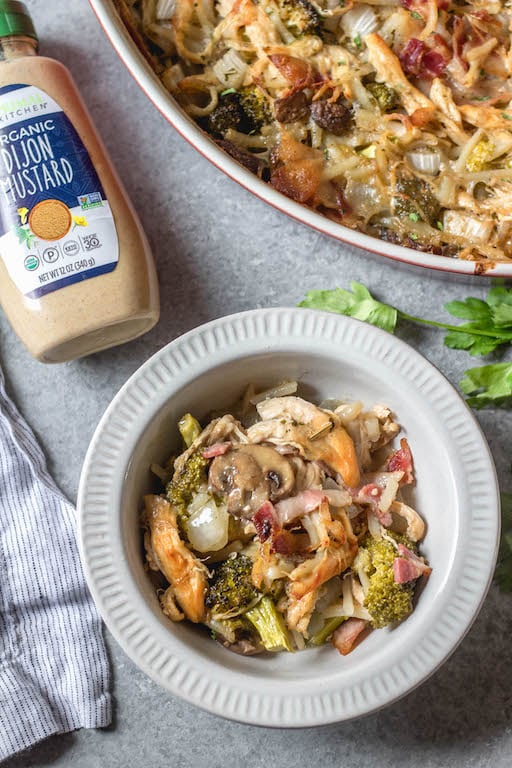 This creamy dijon chicken casserole is an easy and delicious Whole30, Paleo, gluten-free recipe that's great for a weeknight dinner or a simple and healthy meal prep recipe. There's lots of vegetables, bacon and a flavorful dairy-free cream sauce loaded into one casserole dish, and baked to perfection. #whole30recipes #whole30casseroles #paleocasseroles #glutenfreecasseroles #whole30chickenrecipes #easywhole30recipes #mealprep