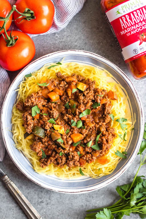 This Whole30 arrabbiata meat sauce with vegetables is made in the instant pot, so everything is cooked in one pot! Made with ground beef and with lots of vegetables snuck in, it's a hearty, cozy and healthy recipe that's great for meal prep. It's also gluten-free, Paleo and low carb/keto. This meat sauce is full of flavor and we love that it's freezer friendly, too. #whole30instantpot #whole30beefrecipes #whole30meatsauce #groundbeefrecipes #paleobeef