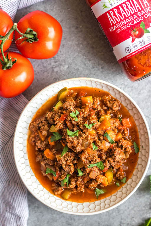 This Whole30 arrabbiata meat sauce with vegetables is made in the instant pot, so everything is cooked in one pot! Made with ground beef and with lots of vegetables snuck in, it's a hearty, cozy and healthy recipe that's great for meal prep. It's also gluten-free, Paleo and low carb/keto. This meat sauce is full of flavor and we love that it's freezer friendly, too. #whole30instantpot #whole30beefrecipes #whole30meatsauce #groundbeefrecipes #paleobeef