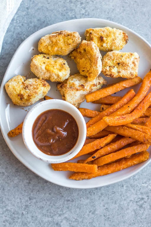 These Whole30 copycat Chick-fil-A chicken nuggets are such a great easy weeknight meal or family friendly go-to recipe for lunch or dinner. They're paleo, low carb, and made with simple ingredients, making them a healthier option than the drive through! These nuggets use pickle brined chicken pieces, then coated in a grain-and gluten-free mixture and cooked in the air fryer to perfection. #whole30airfryer #whole30chickennuggets #chickfilanuggets #glutenfreeairfryer #paleoairfryer #whole30chickenrecipes