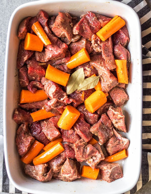This easy oven roasted beef and vegetables recipe is a simple yet healthy dinner recipe with only a few ingredients and little hands on time. It's a family friendly meal ideal that's also Whole30, Paleo, gluten-free and dairy-free. The beef chunks using a chuck roast cook perfectly in one pan with carrots, while the mushrooms and onions are caramelized and mixed in to make this recipe hearty, cozy and delicious! #whole30recipes #whole30beefrecipes #whole30dinner #paleodinner #easywhole30recipes