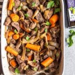 This easy oven roasted beef and vegetables recipe is a simple yet healthy dinner recipe with only a few ingredients and little hands on time. It's a family friendly meal ideal that's also Whole30, Paleo, gluten-free and dairy-free. The beef chunks using a chuck roast cook perfectly in one pan with carrots, while the mushrooms and onions are caramelized and mixed in to make this recipe hearty, cozy and delicious! #whole30recipes #whole30beefrecipes #whole30dinner #paleodinner #easywhole30recipes