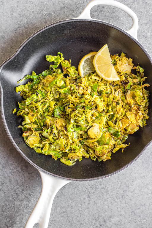 This Whole30 shredded brussels sprouts recipe is the perfect side dish for any breakfast or dinner. They're crispy, sauté really quickly, and only need 3 ingredients. The lemon and garlic flavor pairs well with everything, and keeps the brussels sprouts bright and fresh tasting! These are also low carb/keto, Paleo, gluten-free and just a great way to enjoy your green vegetables! #whole30vegetables #whole30sides #whole30brusselssprouts #ketovegetables #whole30recipes #paleovegetables