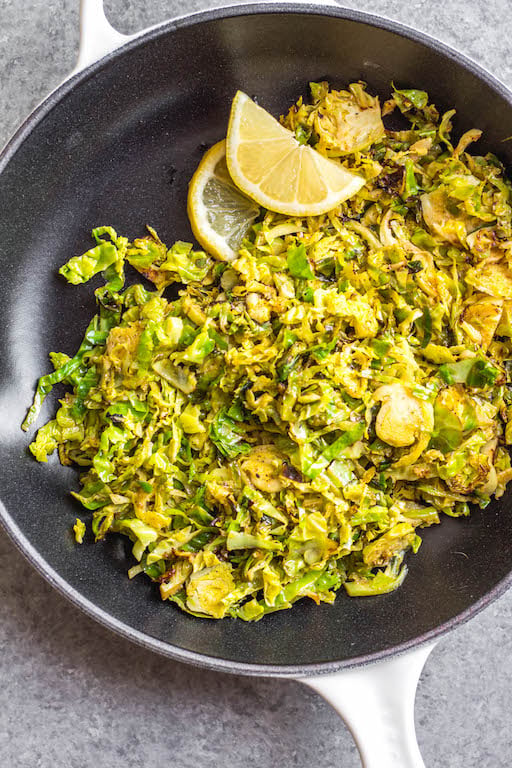 This Whole30 shredded brussels sprouts recipe is the perfect side dish for any breakfast or dinner. They're crispy, sauté really quickly, and only need 3 ingredients. The lemon and garlic flavor pairs well with everything, and keeps the brussels sprouts bright and fresh tasting! These are also low carb/keto, Paleo, gluten-free and just a great way to enjoy your green vegetables! #whole30vegetables #whole30sides #whole30brusselssprouts #ketovegetables #whole30recipes #paleovegetables