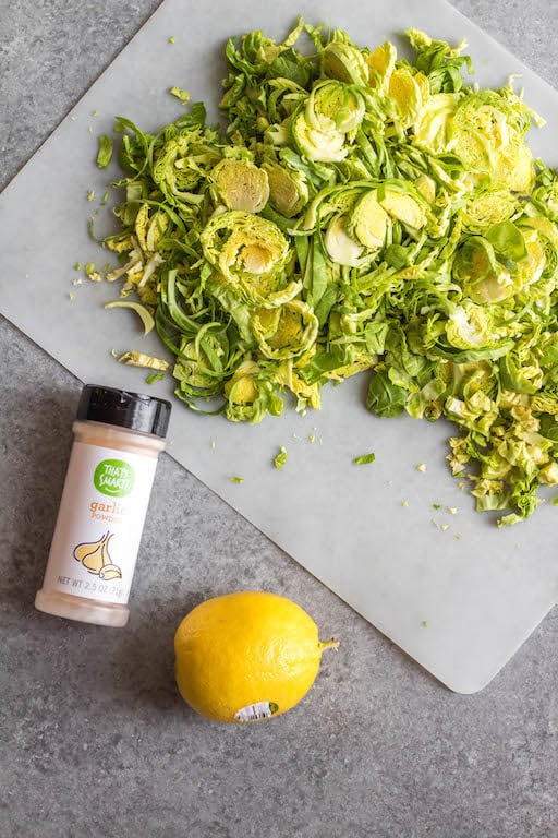 This Whole30 shredded brussels sprouts recipe is the perfect side dish for any breakfast or dinner. They're crispy, sauté really quickly, and only need 3 ingredients. The lemon and garlic flavor pairs well with everything, and keeps the brussels sprouts bright and fresh tasting! These are also low carb/keto, Paleo, gluten-free and just a great way to enjoy your green vegetables! #whole30vegetables #whole30sides #whole30brusselssprouts #ketovegetables #whole30recipes #paleovegetables