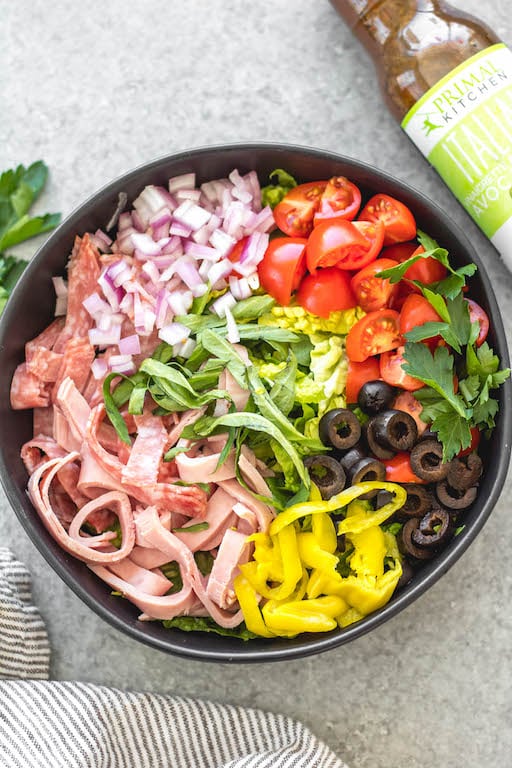 This easy Italian chopped salad is the perfect meal for lunch or dinner that requires no cooking, but is filling, healthy and loaded with vegetables! It's great for a light and fresh lunch, and still delicious enough to serve to guests. It's Whole30, paleo, keto/low carb, and gluten-free, and is a great way to clean all of those vegetables and deli meat out of the fridge! #whole30salad #whole30choppedsalad #ketosalad #lowcarbsalad #italiansalad #whole30recipes