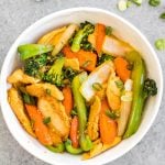 This easy garlic chicken stir fry gets dinner ready to eat in 30 minutes. It's incredibly simple to make for a weeknight meal, full of vegetables like broccoli, carrots and onion, and makes great leftovers for lunch meal prep. This is a family friendly Whole30, paleo, low carb and gluten-free recipe that everyone will love! The sauce is made from only a few pantry staple ingredients, making this a budget friendly one pot recipe, too. #whole30stirfry #garlicchicken #ketochicken #whole30chicken #whole30dinner #lowcarbchicken