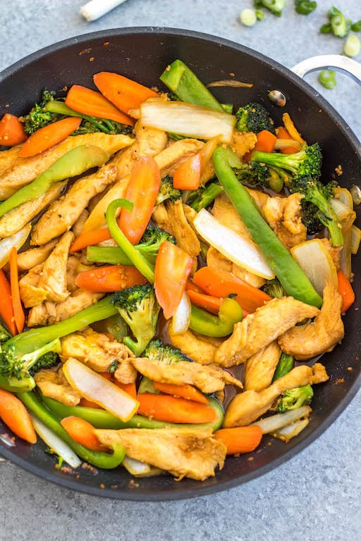 This easy garlic chicken stir fry gets dinner ready to eat in 30 minutes. It's incredibly simple to make for a weeknight meal, full of vegetables like broccoli, carrots and onion, and makes great leftovers for lunch meal prep. This is a family friendly Whole30, paleo, low carb and gluten-free recipe that everyone will love! The sauce is made from only a few pantry staple ingredients, making this a budget friendly one pot recipe, too. #whole30stirfry #garlicchicken #ketochicken #whole30chicken #whole30dinner #lowcarbchicken