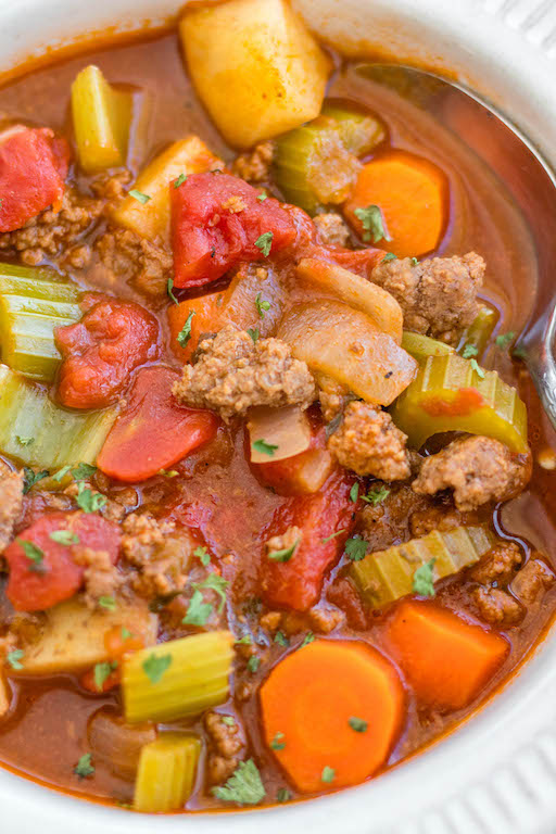 This Whole30 ground beef and vegetable soup is an easy family friendly and budget friendly recipe that's perfect for a quick weeknight meal or for meal prep. It's a cozy soup that's full of filling vegetables like carrots, potatoes and celery, with tons of flavor from a few common spices! It's also paleo, gluten-free and dairy-free, while still being something everyone will love. #whole30soup #whole30beefrecipes #groundbeef #healthysoup #paleo