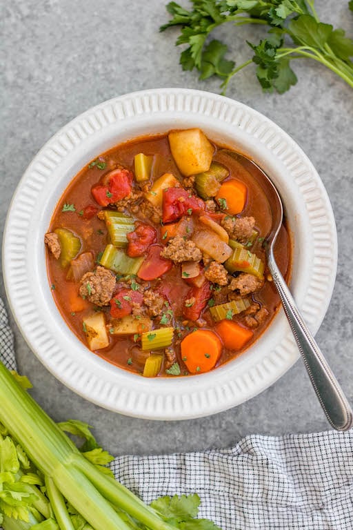 This Whole30 ground beef and vegetable soup is an easy family friendly and budget friendly recipe that's perfect for a quick weeknight meal or for meal prep. It's a cozy soup that's full of filling vegetables like carrots, potatoes and celery, with tons of flavor from a few common spices! It's also paleo, gluten-free and dairy-free, while still being something everyone will love. #whole30soup #whole30beefrecipes #groundbeef #healthysoup #paleo