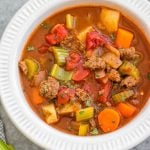 This Whole30 ground beef and vegetable soup is an easy family friendly and budget friendly recipe that's perfect for a quick weeknight meal or for meal prep. It's a cozy soup that's full of filling vegetables like carrots, potatoes and celery, with tons of flavor from a few common spices! It's also paleo, gluten-free and dairy-free, while still being something everyone will love. #whole30soup #whole30beefrecipes #groundbeef #healthysoup #paleo