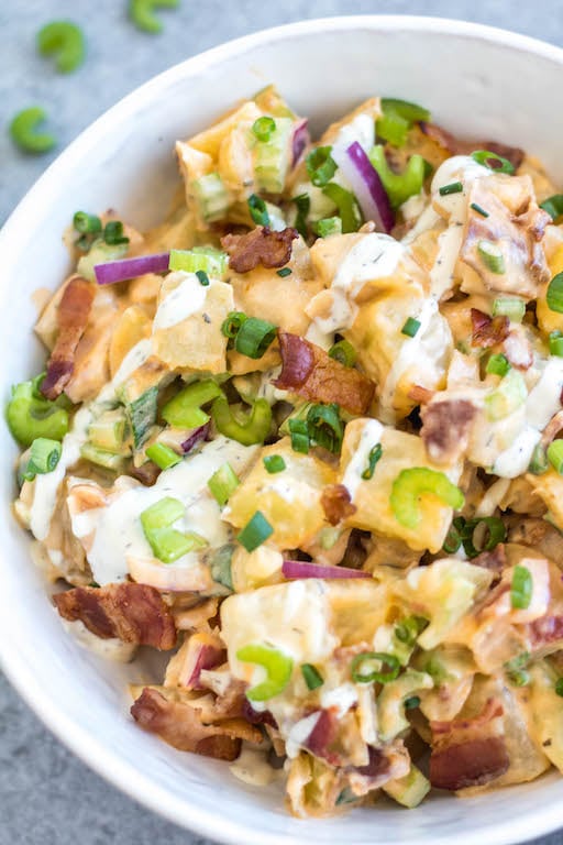 This Whole30 buffalo ranch potato salad recipe is a healthy, easy side dish or vegetable recipe that's a perfect addition to any meal or gathering. It's full of flavor from the sauces, bacon, golden potatoes, onion and celery, while being dairy-free, gluten-free and Paleo. It's a family friendly recipe that is also great for meal prep to pair with a protein and eat all week long. #whole30potato #buffalo #ranchrecipes #whole30potatosalad #bacon #whole30vegetablerecipes