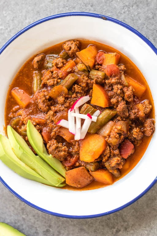 This easy slow cooker sweet potato chili is a meal prep dream! It takes under 30 minutes to throw together in a crock pot, is filling, healthy and reheats great for meals throughout the week. With vegetables like sweet potatoes, green beans, onion, and celery, canned items, and delicious chili spices, this Whole30 chili doesn't disappoint while being budget friendly. It's also paleo, gluten-free and dairy-free! #whole30chili #whole30sweetpotatorecipes #paleochili #whole30slowcooker #slowcookerchili