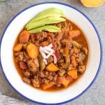 This easy slow cooker sweet potato chili is a meal prep dream! It takes under 30 minutes to throw together in a crock pot, is filling, healthy and reheats great for meals throughout the week. With vegetables like sweet potatoes, green beans, onion, and celery, canned items, and delicious chili spices, this Whole30 chili doesn't disappoint while being budget friendly. It's also paleo, gluten-free and dairy-free! #whole30chili #whole30sweetpotatorecipes #paleochili #whole30slowcooker #slowcookerchili