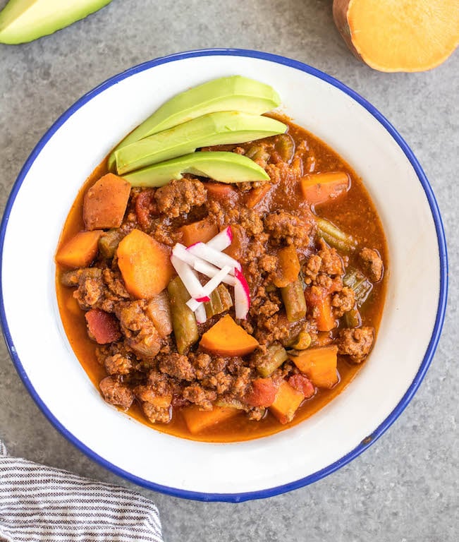 This easy slow cooker sweet potato chili is a meal prep dream! It takes under 30 minutes to throw together in a crock pot, is filling, healthy and reheats great for meals throughout the week. With vegetables like sweet potatoes, green beans, onion, and celery, canned items, and delicious chili spices, this Whole30 chili doesn't disappoint while being budget friendly. It's also paleo, gluten-free and dairy-free! #whole30chili #whole30sweetpotatorecipes #paleochili #whole30slowcooker #slowcookerchili