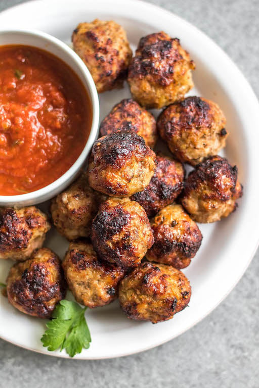 These easy ground pork meatballs are made in the air fryer, take under 20 minutes, and only need a few simple ingredients. No need to turn your oven on to get perfect, juicy and healthy meatballs! These air fryer meatballs are Whole30, paleo, keto (low carb), and gluten-free. They're ideal for a quick weeknight dinner, and work great for a meal prep recipe because they reheat so well, too! #airfryerrecipes #airfryermeatballs #whole30meatballs #porkrecipes #whole30 #keto