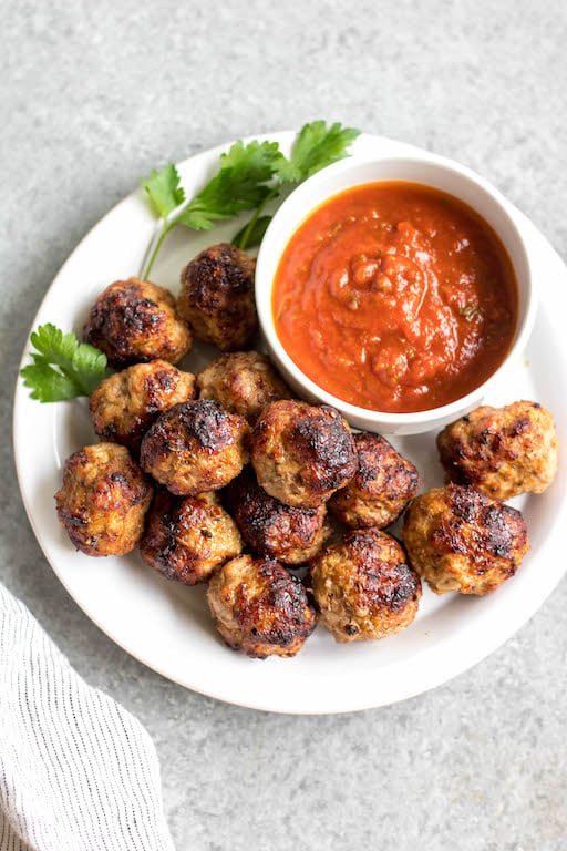 These easy ground pork meatballs are made in the air fryer, take under 20 minutes, and only need a few simple ingredients. No need to turn your oven on to get perfect, juicy and healthy meatballs! These air fryer meatballs are Whole30, paleo, keto (low carb), and gluten-free. They're ideal for a quick weeknight dinner, and work great for a meal prep recipe because they reheat so well, too! #airfryerrecipes #airfryermeatballs #whole30meatballs #porkrecipes #whole30 #keto