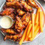 These smoked BBQ wings are easy, don't take very long, and totally delicious! They also only require a few ingredients, and are Whole30, Paleo, gluten-free and keto. Unlike meats when cooked on a smoker, wings are straightforward and not very fussy. These wings are perfectly juicy, have a great smoky flavor and great for any gathering! #whole30chickenwings #smokedchicken #paleochicken #ketochicken #ketosmokerrecipes