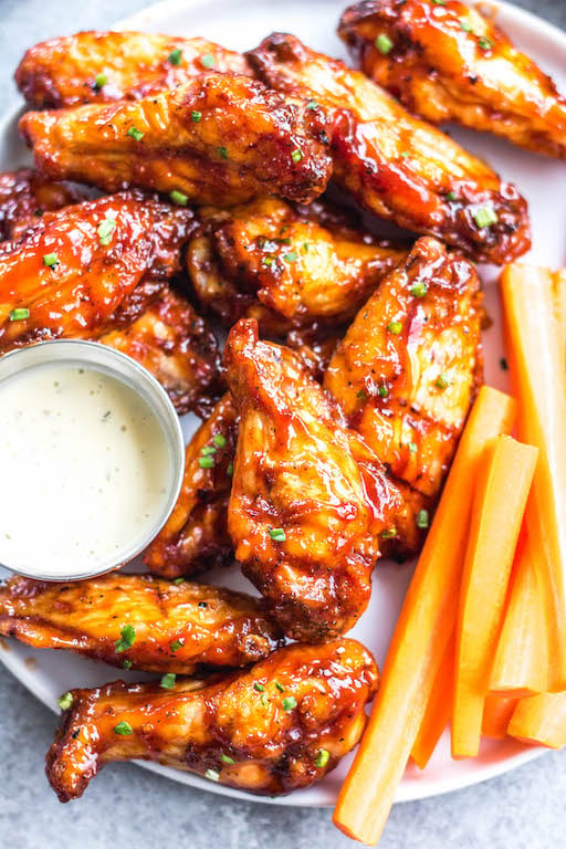 These smoked BBQ wings are easy, don't take very long, and totally delicious! They also only require a few ingredients, and are Whole30, Paleo, gluten-free and keto. Unlike meats when cooked on a smoker, wings are straightforward and not very fussy. These wings are perfectly juicy, have a great smoky flavor and great for any gathering! #whole30chickenwings #smokedchicken #paleochicken #ketochicken #ketosmokerrecipes