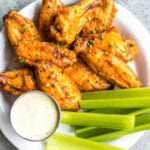 These Whole30 smoked buffalo wings are simple, easy to prepare, and always a crowd pleaser! These chicken wings require a few ingredients, and are not only Whole30, but also Paleo, gluten-free and low carb/keto. These wings are perfect for a healthy weeknight dinner, meal prep, or any gathering. Smoking wings is a straightforward process that anyone can master! #whole30chickenwings #whole30chicken #smoker #smokedwings #buffalowings #ketochicken