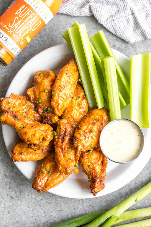 These Whole30 smoked buffalo wings are simple, easy to prepare, and always a crowd pleaser! These chicken wings require a few ingredients, and are not only Whole30, but also Paleo, gluten-free and low carb/keto. These wings are perfect for a healthy weeknight dinner, meal prep, or any gathering. Smoking wings is a straightforward process that anyone can master! #whole30chickenwings #whole30chicken #smoker #smokedwings #buffalowings #ketochicken