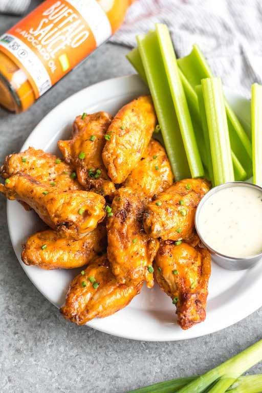 These Whole30 smoked buffalo wings are simple, easy to prepare, and always a crowd pleaser! These chicken wings require a few ingredients, and are not only Whole30, but also Paleo, gluten-free and low carb/keto. These wings are perfect for a healthy weeknight dinner, meal prep, or any gathering. Smoking wings is a straightforward process that anyone can master! #whole30chickenwings #whole30chicken #smoker #smokedwings #buffalowings #ketochicken