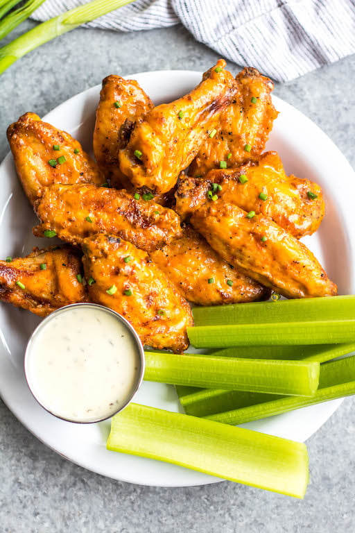 These Whole30 smoked buffalo wings are simple, easy to prepare, and always a crowd pleaser! These chicken wings require a few ingredients, and are not only Whole30, but also Paleo, gluten-free and low carb/keto. These wings are perfect for a healthy weeknight dinner, meal prep, or any gathering. Smoking wings is a straightforward process that anyone can master! #whole30chickenwings #whole30chicken #smoker #smokedwings #buffalowings #ketochicken