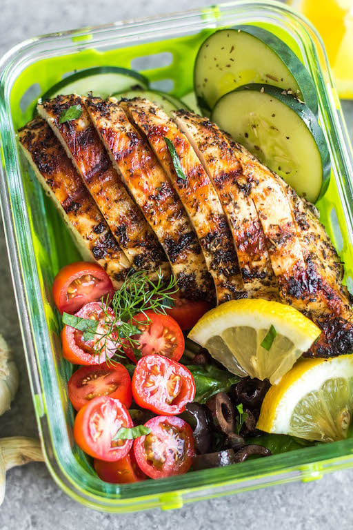 These healthy grilled Greek chicken bowls are perfect for weekday lunches or an easy dinner! Made with only a few simple ingredients, boneless chicken breasts, and fresh vegetables like tomatoes, cucumbers and green pepper, meal prep couldn't be more simple! This grilled chicken is also Whole30, paleo, low carb (keto), and gluten-free. #grilledchicken #whole30greekchicken #paleochicken #ketogrilling #mealprep