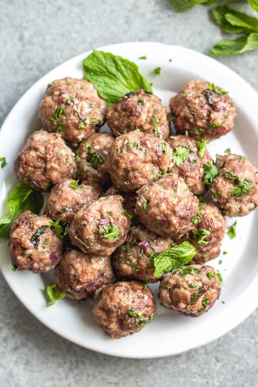 These easy greek meatballs are are a quick weeknight dinner or meal prep recipe that's Whole30, low carb, paleo and gluten-free. They freeze well, are simple to prepare and bake in the oven in under 30 minutes. Using ground beef, ground pork and only a few spices, these healthy meatballs are full of flavor and will be a family favorite! #whole30recipes #meatballrecipes #greekmeatballs #keto #paleo