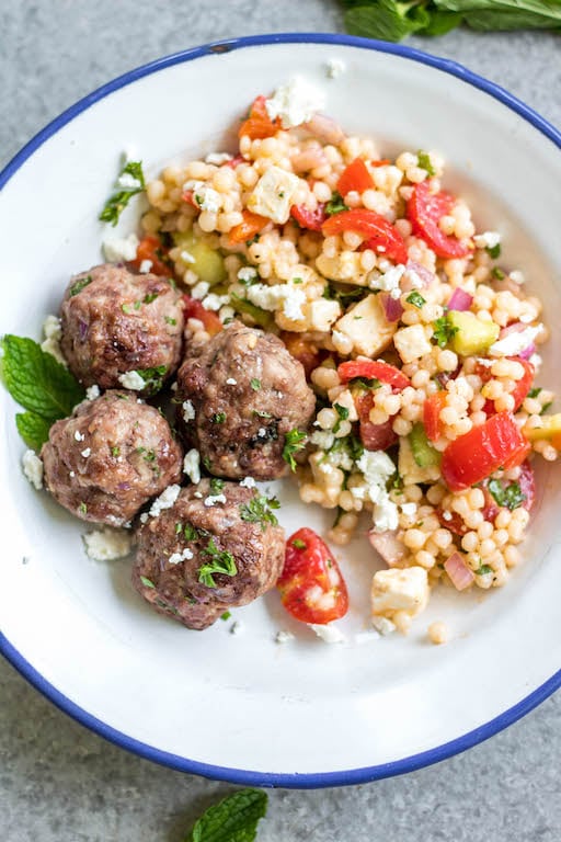 These easy greek meatballs are are a quick weeknight dinner or meal prep recipe that's Whole30, low carb, paleo and gluten-free. They freeze well, are simple to prepare and bake in the oven in under 30 minutes. Using ground beef, ground pork and only a few spices, these healthy meatballs are full of flavor and will be a family favorite! #whole30recipes #meatballrecipes #greekmeatballs #keto #paleo