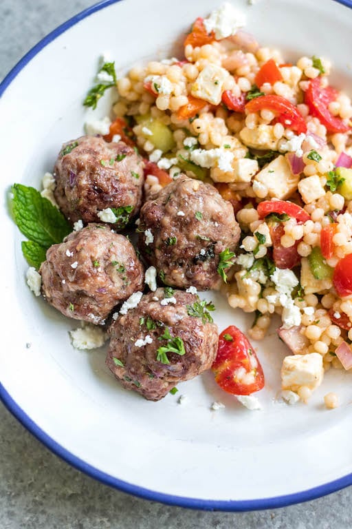 These easy greek meatballs are are a quick weeknight dinner or meal prep recipe that's Whole30, low carb, paleo and gluten-free. They freeze well, are simple to prepare and bake in the oven in under 30 minutes. Using ground beef, ground pork and only a few spices, these healthy meatballs are full of flavor and will be a family favorite! #whole30recipes #meatballrecipes #greekmeatballs #keto #paleo