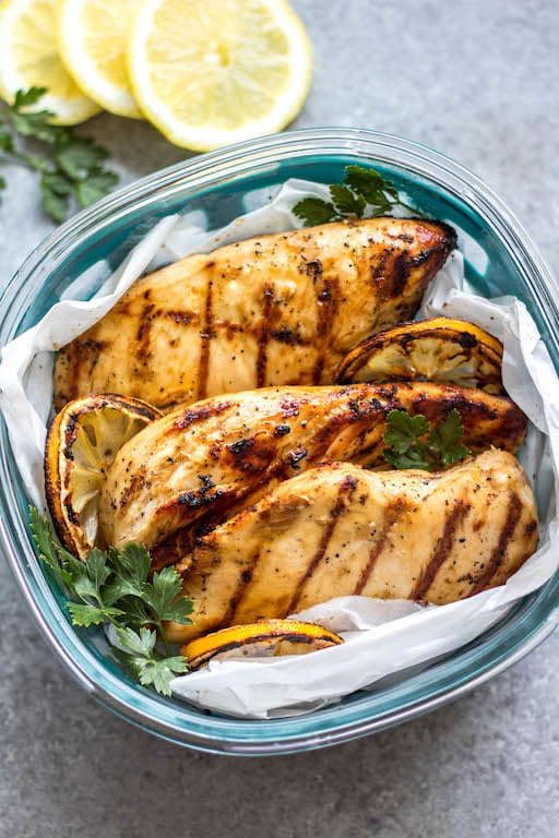 These easy grilled lemon pepper chicken breasts are perfect for a simple weeknight dinner or to meal prep your protein for the week. With only a few ingredients, they cook quickly without much hands on time or dirty dishes. These Whole30 grilled chicken breasts are juicy with a bright lemon flavor that pairs well with a little kick from the pepper. It's a family friendly recipe that is gluten-free, low carb and paleo so they can please a crowd, too! #whole30grilling #grilledchicken #ketochicken #whole30chicken