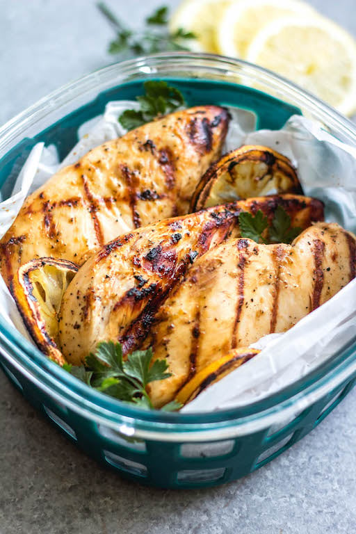 These easy grilled lemon pepper chicken breasts are perfect for a simple weeknight dinner or to meal prep your protein for the week. With only a few ingredients, they cook quickly without much hands on time or dirty dishes. These Whole30 grilled chicken breasts are juicy with a bright lemon flavor that pairs well with a little kick from the pepper. It's a family friendly recipe that is gluten-free, low carb and paleo so they can please a crowd, too! #whole30grilling #grilledchicken #ketochicken #whole30chicken