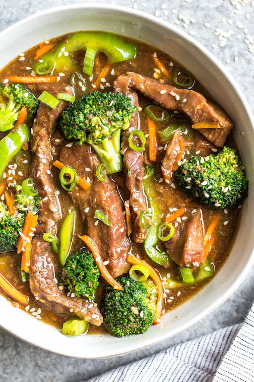 This easy slow cooker Mongolian beef is quick to throw into the crock pot, and is Whole30, Paleo, low carb and gluten-free. It only needs a handful of simple ingredients to make the sauce, along with flank steak, carrots, bell pepper and broccoli for the vegetables. This family friendly meal is perfect for dinner or for a healthy meal prep recipe! #whole30recipes #whole30beef #mongolianbeef #slowcooker #crockpot