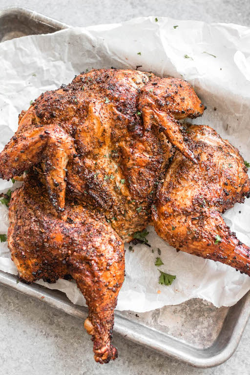 This recipe is for the best smoked butterfly chicken. It'll be your go-to method for smoking a whole chicken on a pellet grill that's Whole30, gluten-free, low carb and paleo. The dry rub is made with simple, sugar-free ingredients and by using the spatchcock method, the chicken skin gets crispy while keeping the meat tender, juicy and full of flavor. This is a great family friendly recipe that works well for meal prep, too. #whole30chicken #smokerrecipes #wholechicken #pelletgrill #butterflychicken